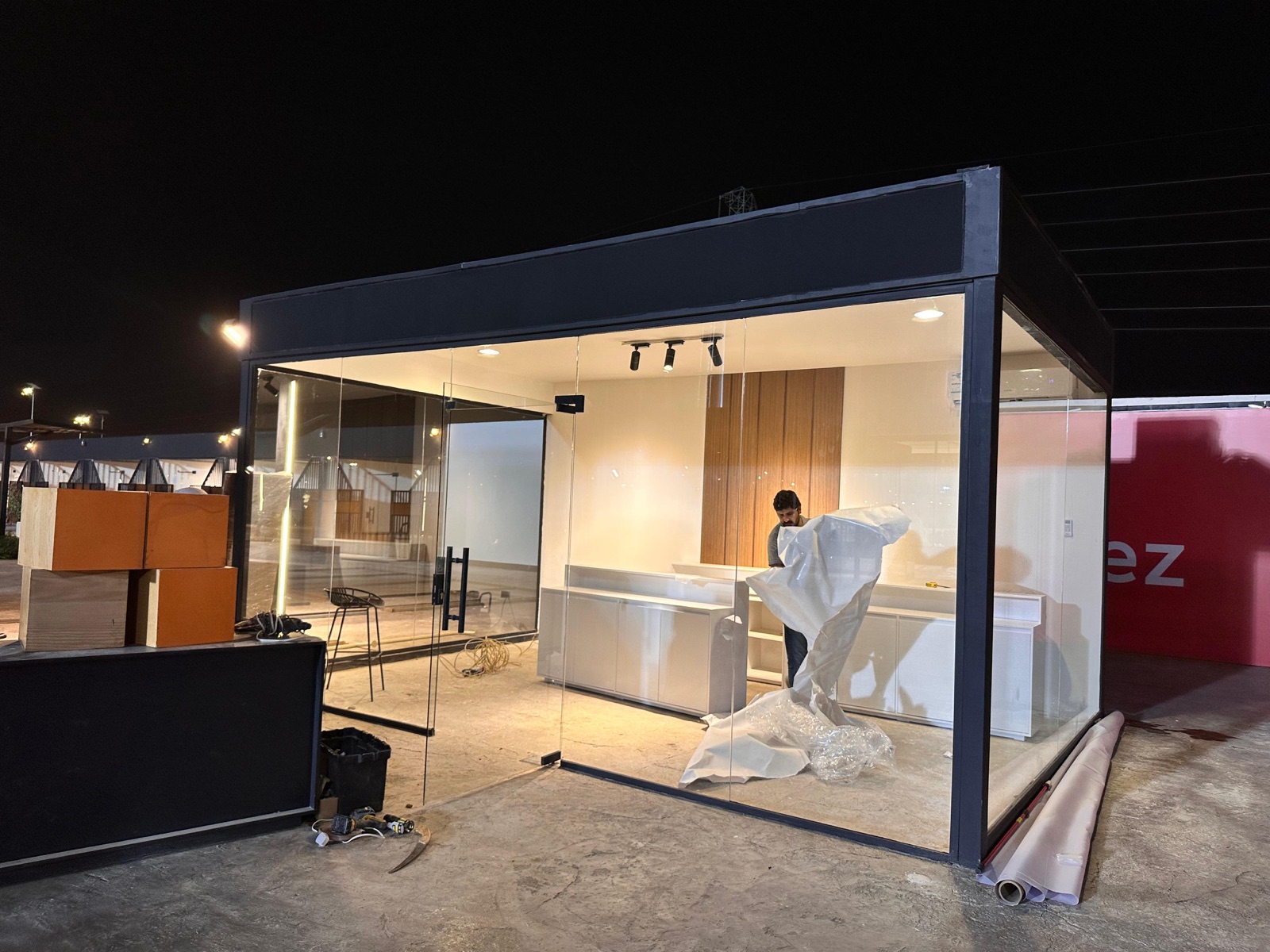 Glass-walled exhibition booth installed on-site at night by the Darb team in Riyadh